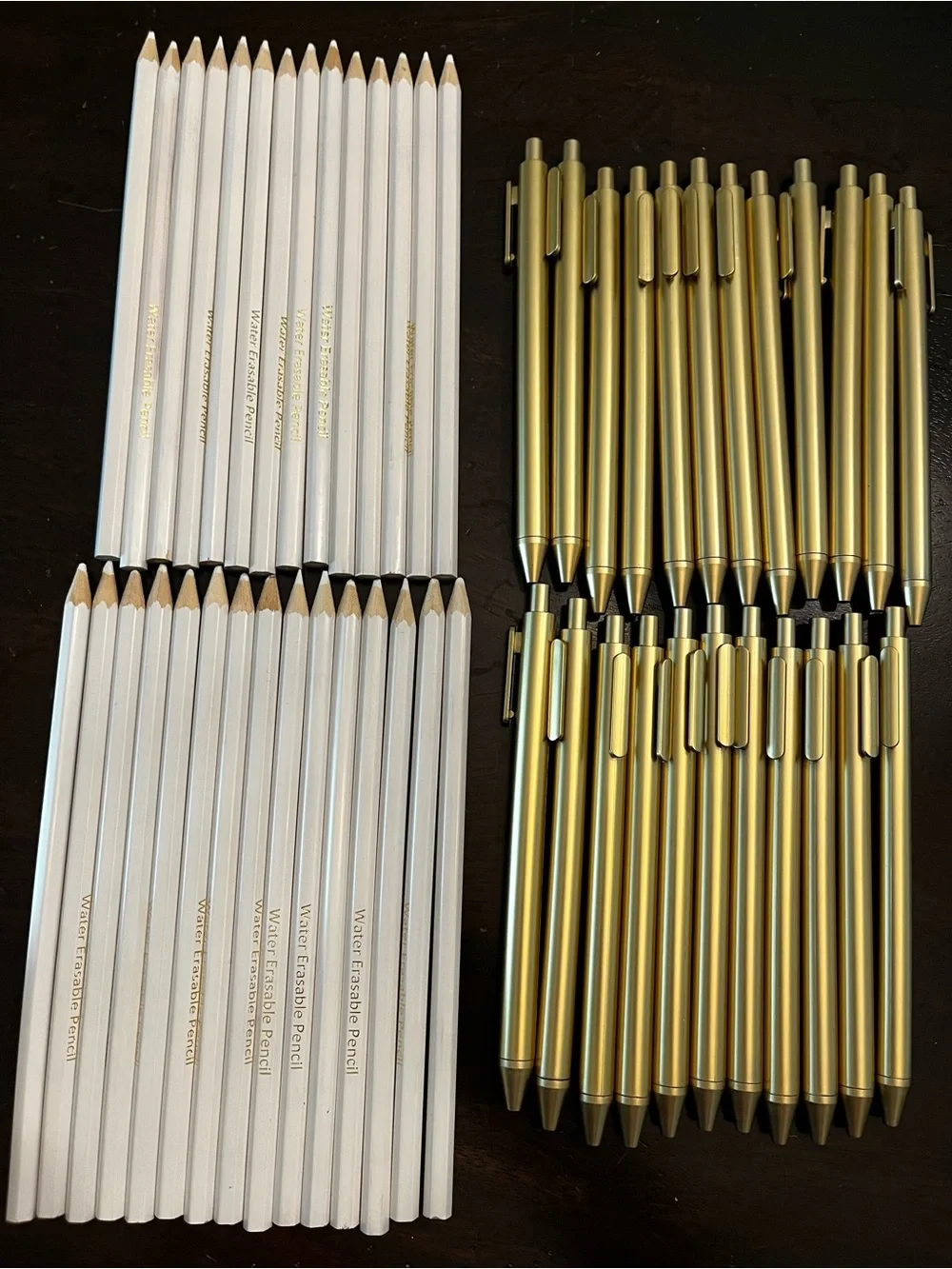 Gold Ballpoint Pens and White Pencils